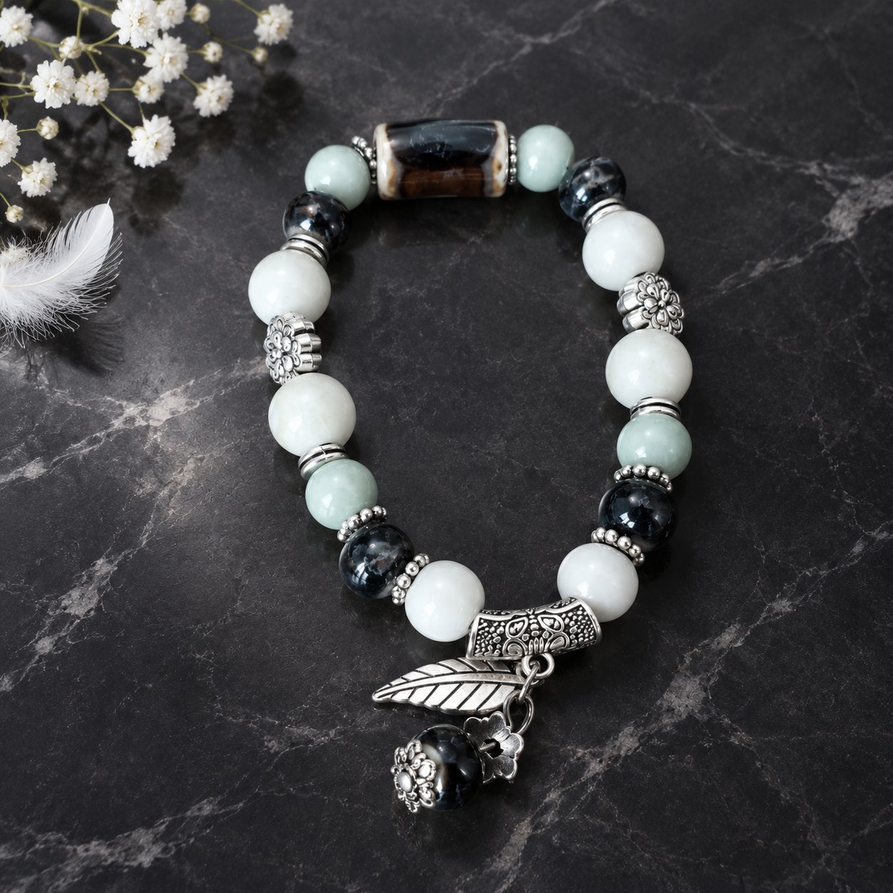 First Frost — white jade tone ceramic bracelet with silver leaf charm on black marble