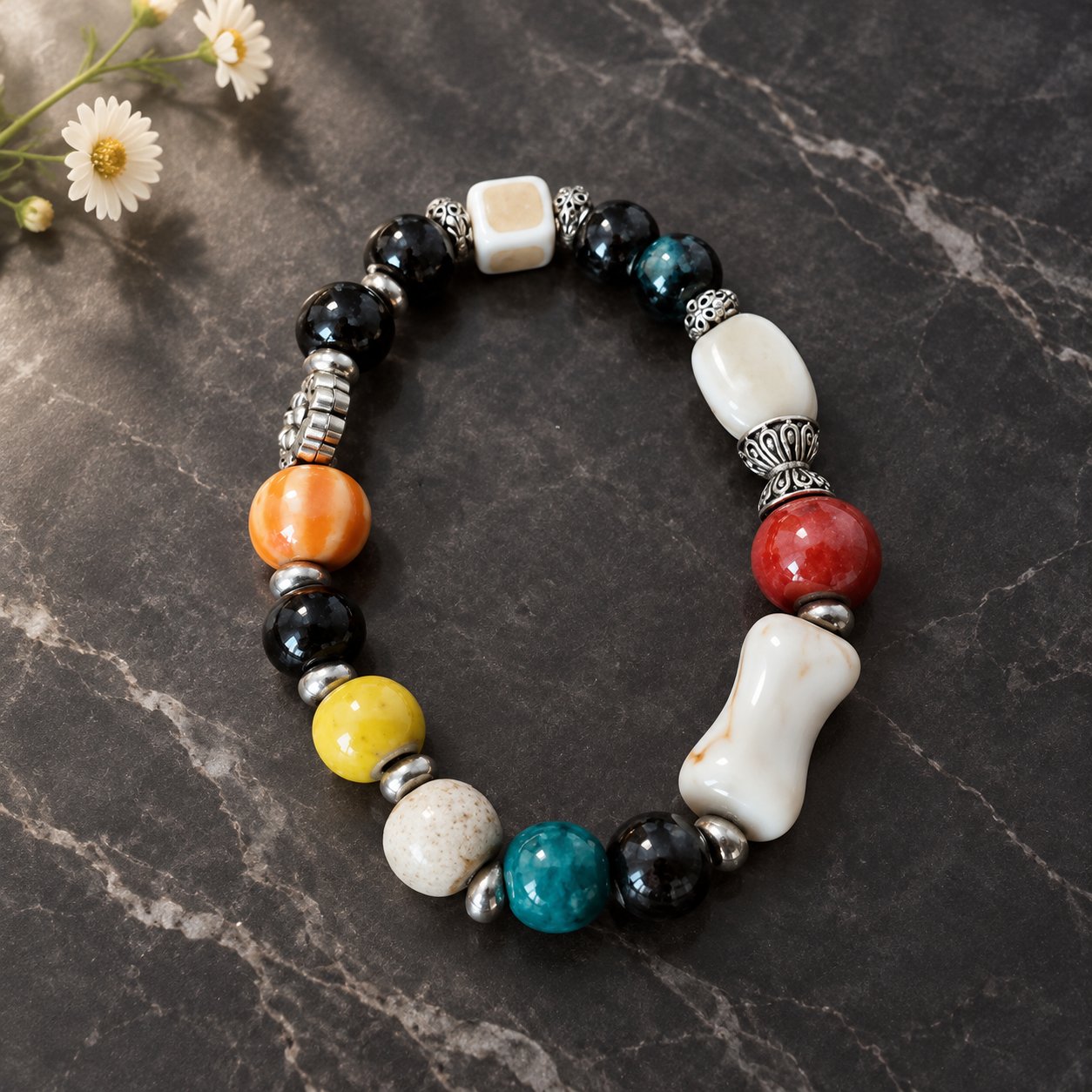 Kiln Carnival — multicolor ceramic beaded bracelet with silver accents on black marble